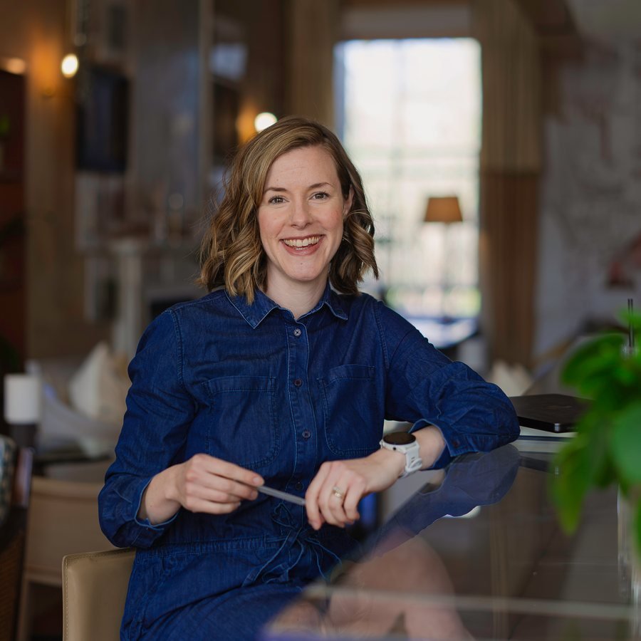 Liv smiling at a café table in Bath